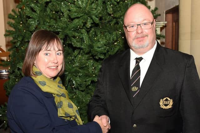 Brighouse and Rastrick Band President Lyndon Stacey makes apresentation to Brighouse High School Head, Liz Cresswell.