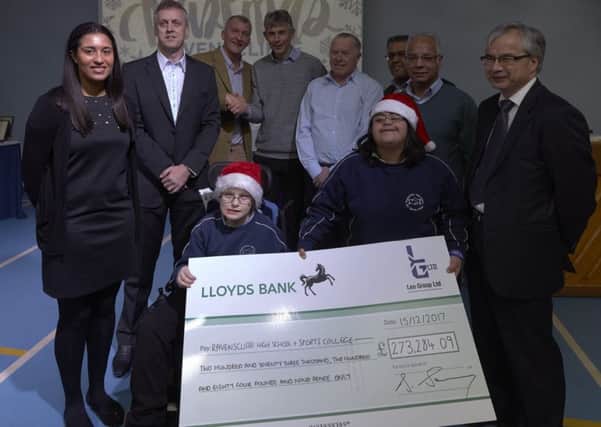Top total: Mr Swarij presented the cheque to Ravenscliffe pupils Jake Powell and Maha Niazi
