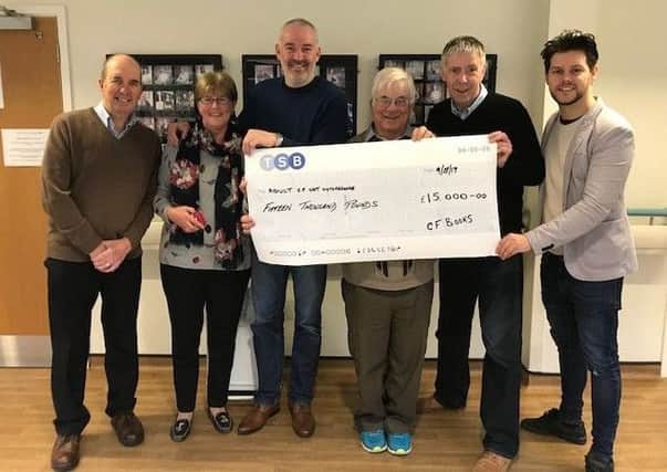 All smiles: Prof Kevin Webb (centre) is presented with a cheque for Â£15,000 by, from the left, Steve McHugh, Anne McHugh, James Holland, Keith Rudman and Andy Duggan