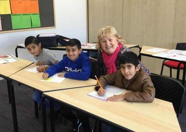 Linda Brown with pupils at an Inte11ect Tutoring session at North Halifax Grammar School