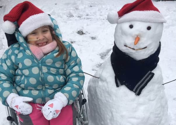 Smiles in the snow from Matilda and her snowman Simon