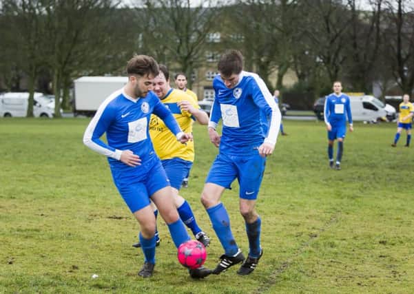 Sunday football - Ryburn Valley v Hollins Holme. Thomas Hirst for Ryburn, with Dan Boyd, left, and George Bamford, right, for Hollins.