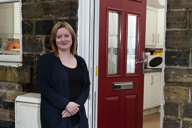 Tony Pollard's tenant Faye Greenwood with new flood doors at her Walsden home. Picture by Chris Lord Photography
