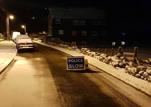 Walker Lane, linking Hebden Bridge and Old Town, has been closed by police while a vehicle which has slid into a wall and blocked the route can be safely recovered