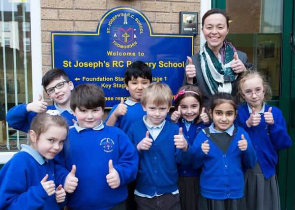 Thumbs up: Headteacher Elizabeth Lloyd, with Year 2 children at St Josephs School, Todmorden