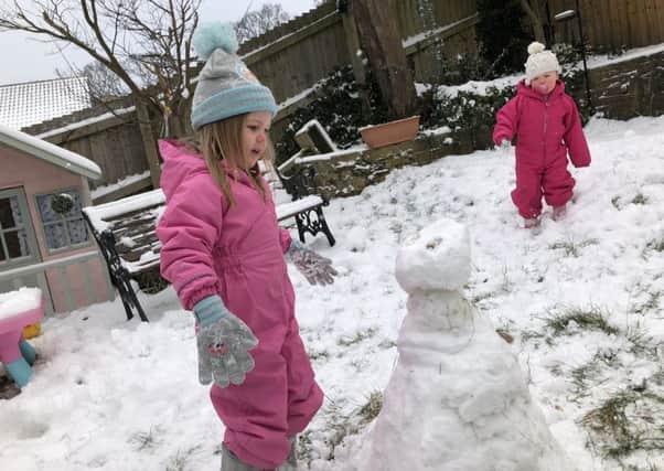 Enjoying the snow by building a snowman