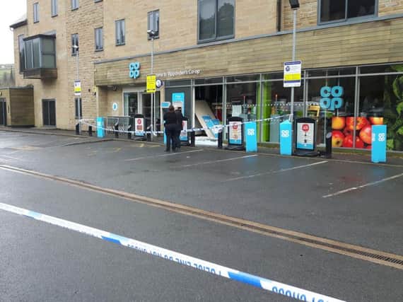 A police cordon remains in place at the Co-op in Oldham Road, Ripponden, this morning.