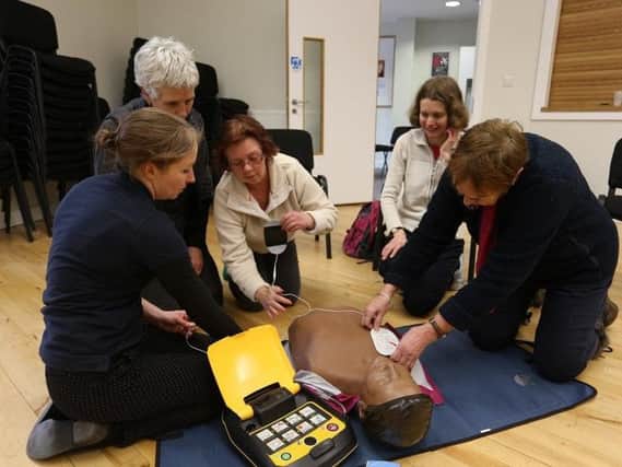 Volunteers taking part in a training sesson on how to use the new equipment in an emergency