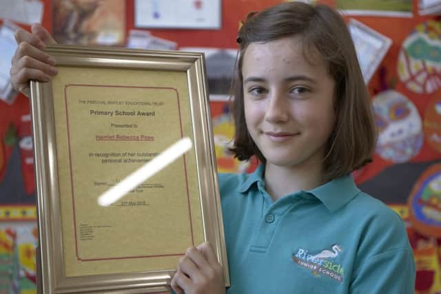 Eleve-year-old Hattie Pope with her award from the Percival Whitley Trust.